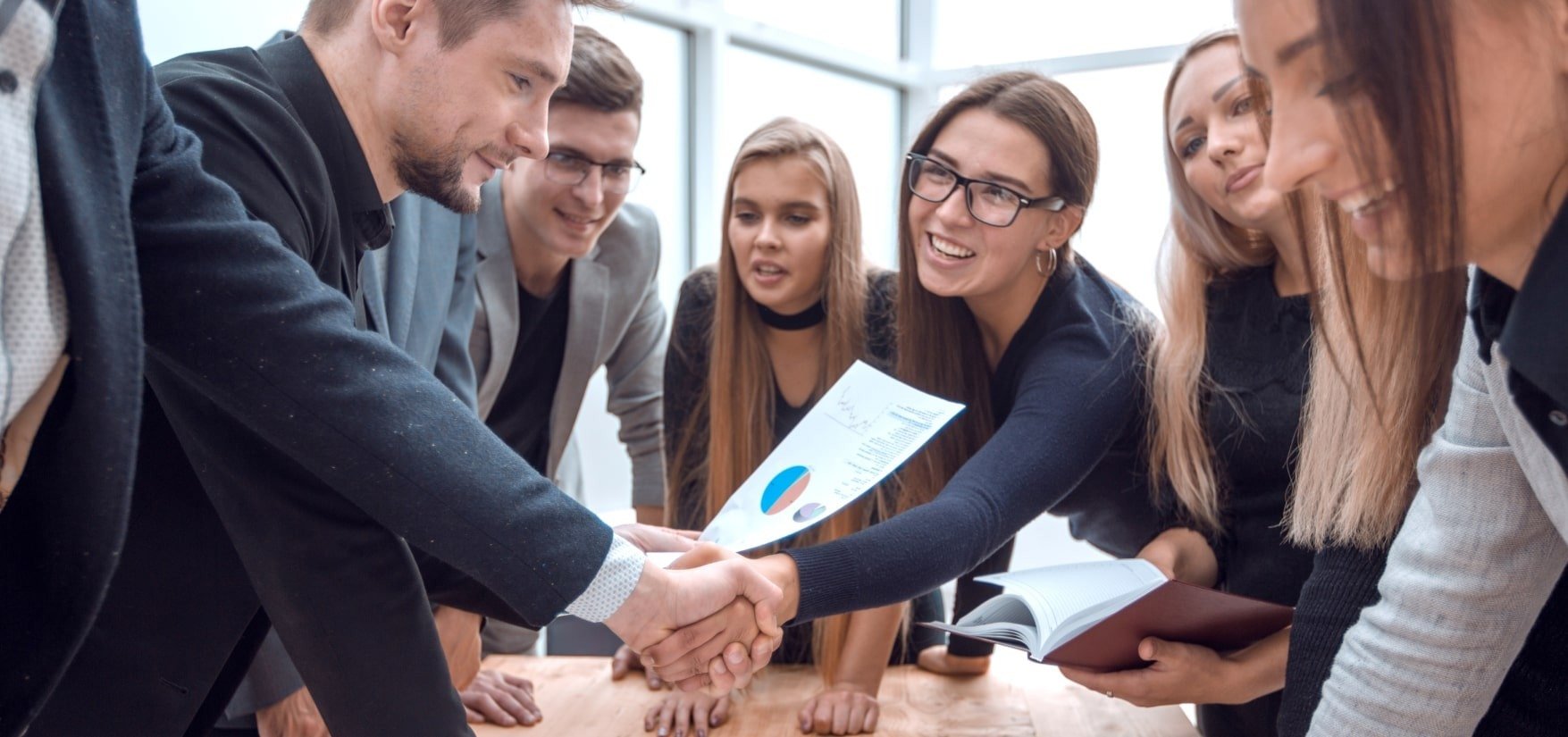 A group of business consulting service professionals shaking hands