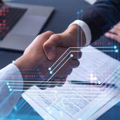 Two professionals who work for an IT consulting company are shaking hands.